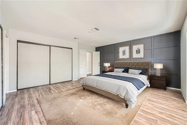 3954 Edgemoor Way, Las Vegas, NV 89121 - bedroom with a decorative wall and light wood-type flooring