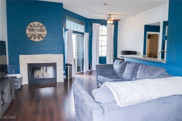 living room featuring dark hardwood / wood-style floors and ceiling fan