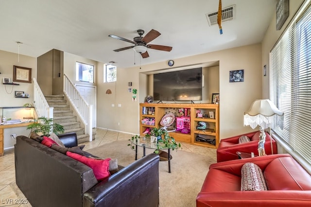 tiled living room with ceiling fan and a healthy amount of sunlight