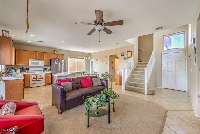 living room with light tile patterned flooring and ceiling fan