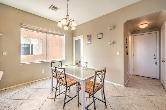 dining room featuring a notable chandelier and light tile patterned floors