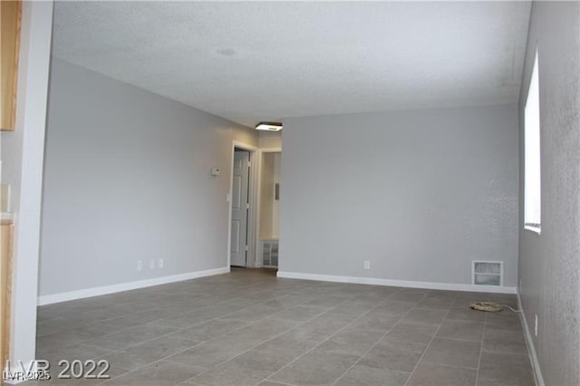 spare room featuring a textured ceiling