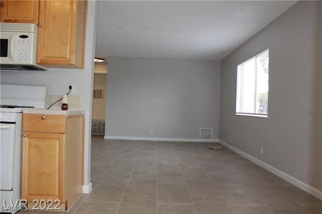 kitchen with light tile patterned floors and stove