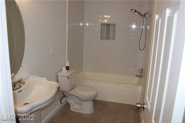 full bathroom with tiled shower / bath, sink, tile patterned floors, and toilet