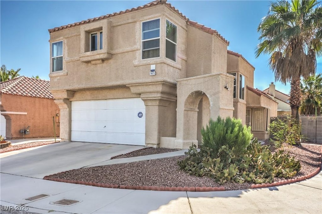 mediterranean / spanish-style home with a garage