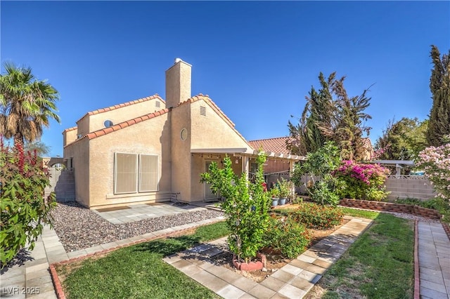 back of property with a patio