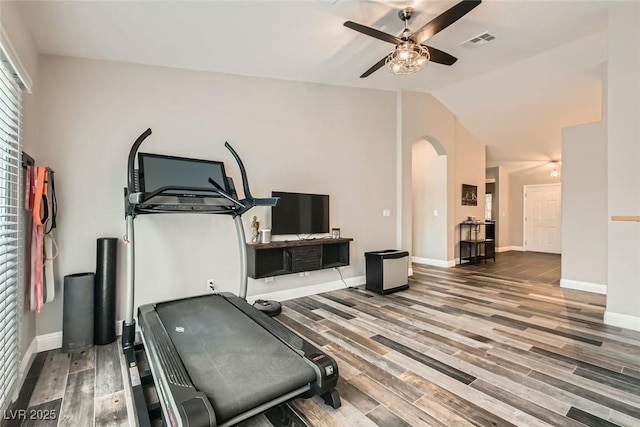 exercise room with hardwood / wood-style flooring, ceiling fan, and vaulted ceiling