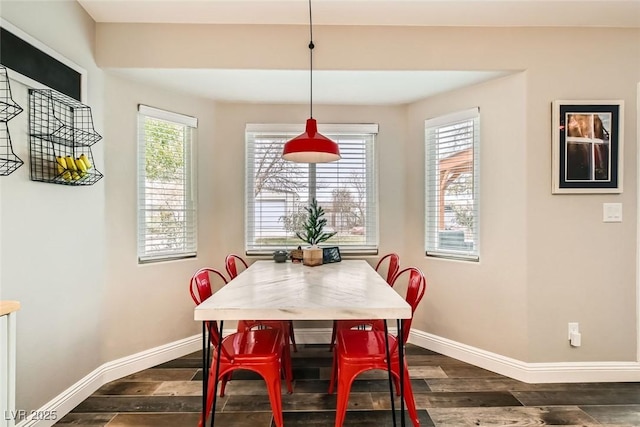 dining area featuring dark wood-type flooring and a wealth of natural light