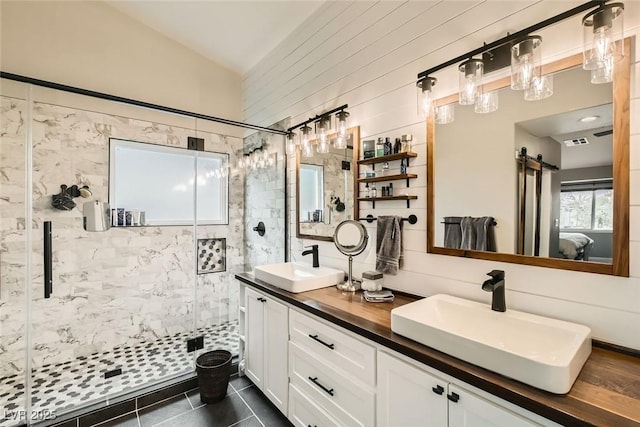 bathroom featuring walk in shower, vanity, tile patterned flooring, and vaulted ceiling