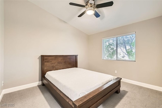 carpeted bedroom with vaulted ceiling and ceiling fan