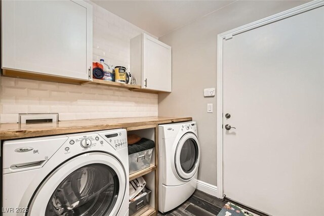 laundry room with cabinets, washer and dryer, and dark hardwood / wood-style flooring