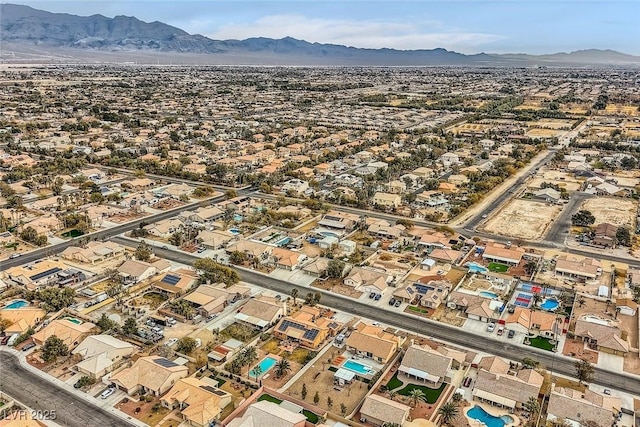 birds eye view of property with a mountain view