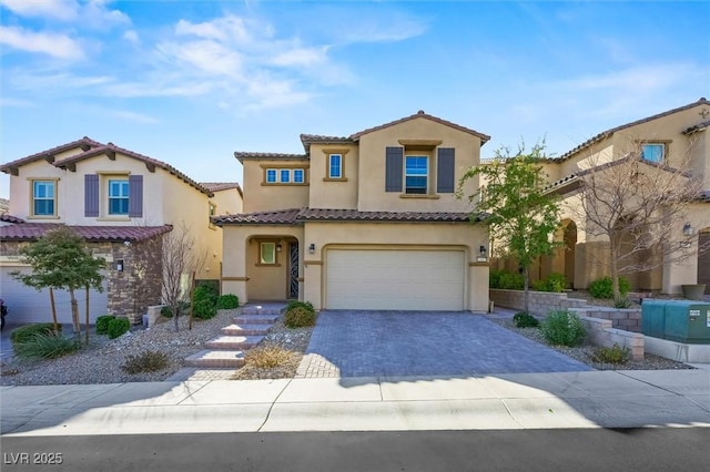 mediterranean / spanish-style house with a garage