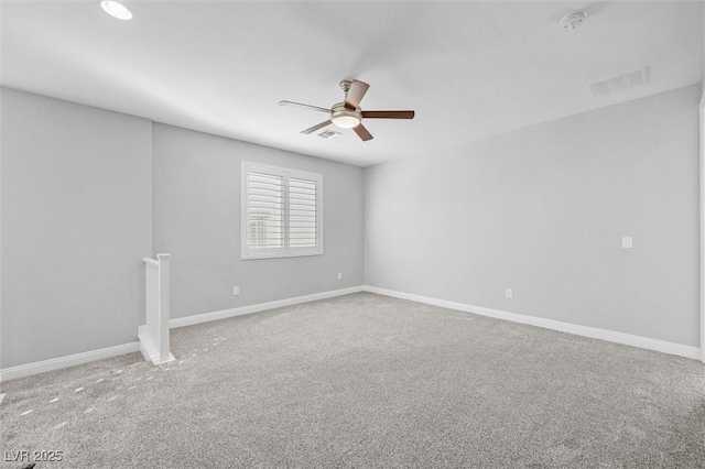 spare room featuring ceiling fan and carpet flooring