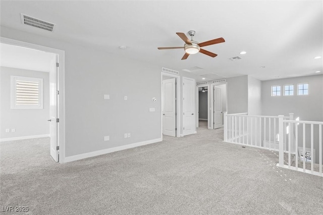 carpeted empty room with ceiling fan