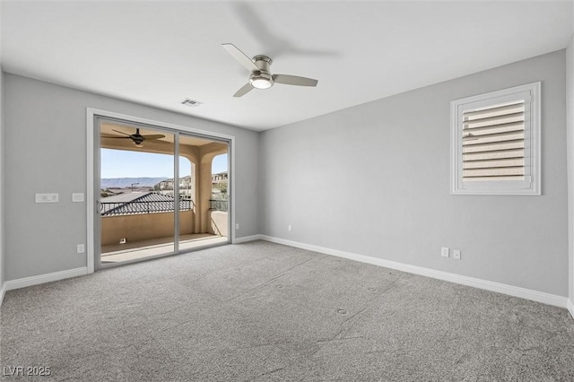 carpeted spare room featuring ceiling fan