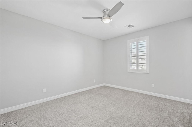 spare room featuring carpet and ceiling fan