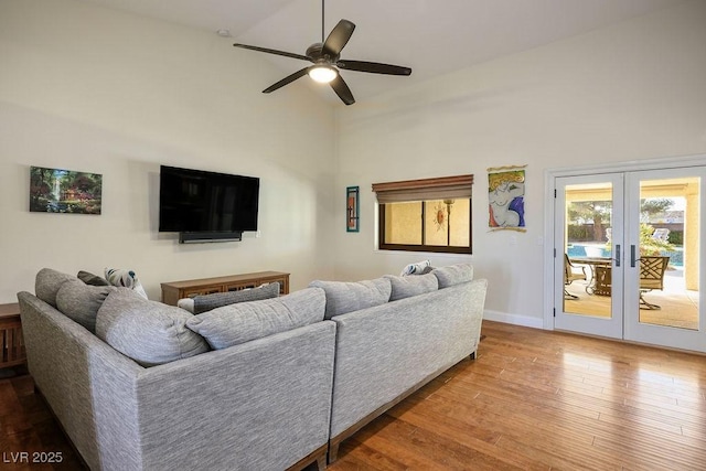 living room featuring wood-type flooring, high vaulted ceiling, french doors, and ceiling fan