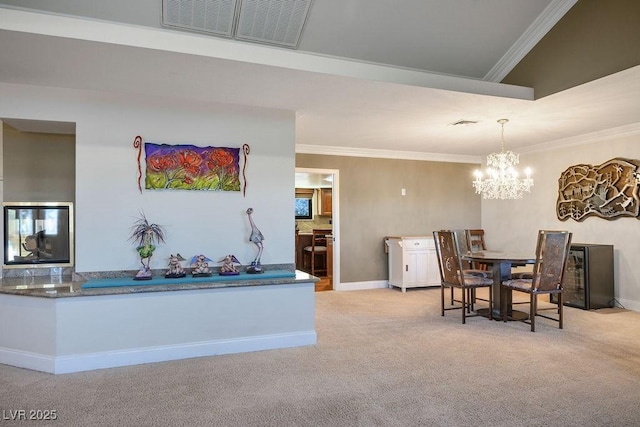 carpeted dining room featuring crown molding and a chandelier