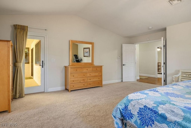 bedroom with lofted ceiling and carpet floors