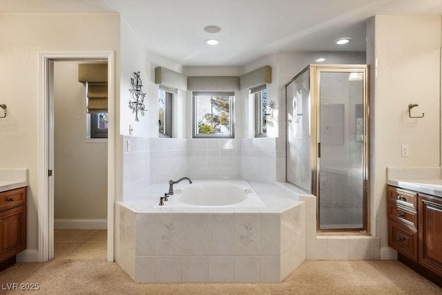 bathroom with independent shower and bath and vanity