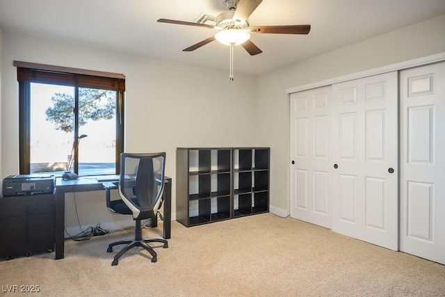 office space with ceiling fan and light carpet