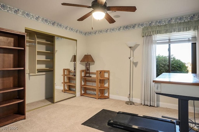 exercise room featuring ceiling fan and carpet floors