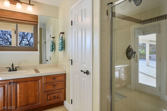 bathroom featuring vanity, a healthy amount of sunlight, and walk in shower