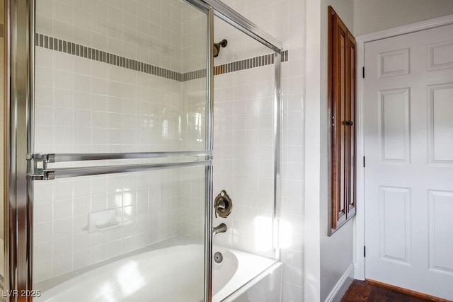 bathroom with shower / bath combination with glass door