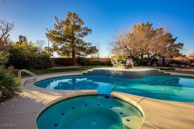 view of swimming pool with a fireplace and an in ground hot tub