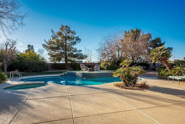 view of swimming pool featuring a patio and an in ground hot tub