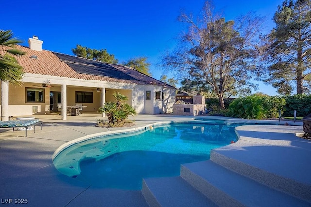 view of pool with ceiling fan and a patio area