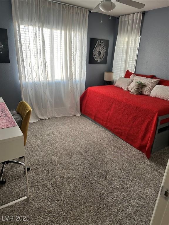 carpeted bedroom featuring ceiling fan