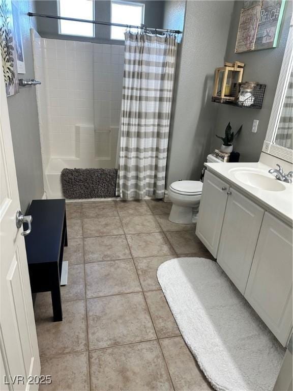 full bathroom featuring vanity, toilet, tile patterned flooring, and shower / bath combo with shower curtain