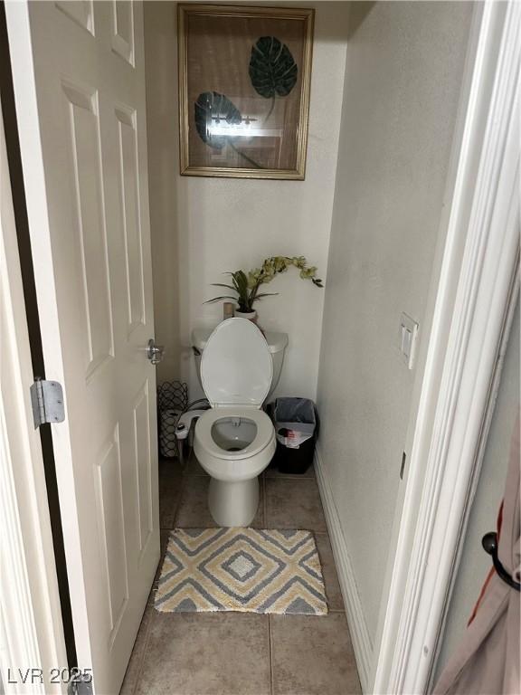 bathroom with tile patterned flooring and toilet