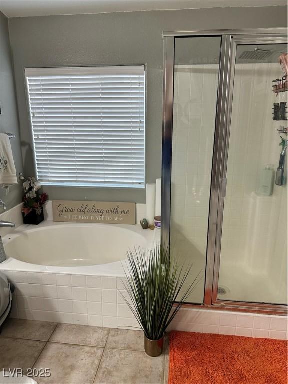 bathroom featuring plus walk in shower and tile patterned flooring