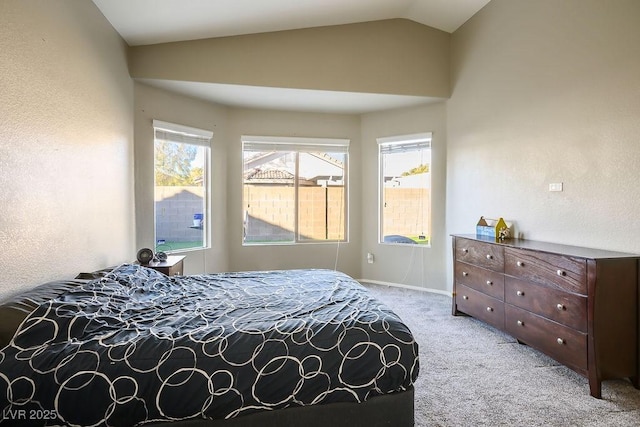 carpeted bedroom featuring lofted ceiling