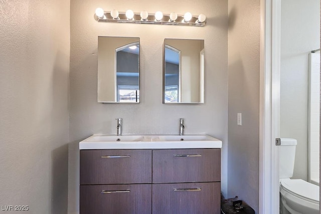 bathroom featuring vanity and toilet