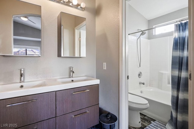 full bathroom featuring vanity, shower / bathtub combination with curtain, and toilet