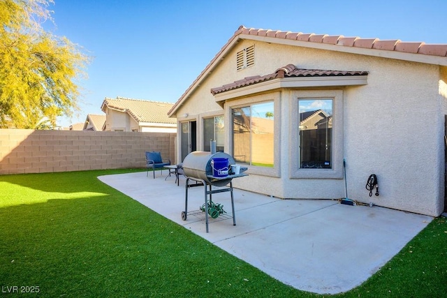 rear view of property featuring a patio and a yard