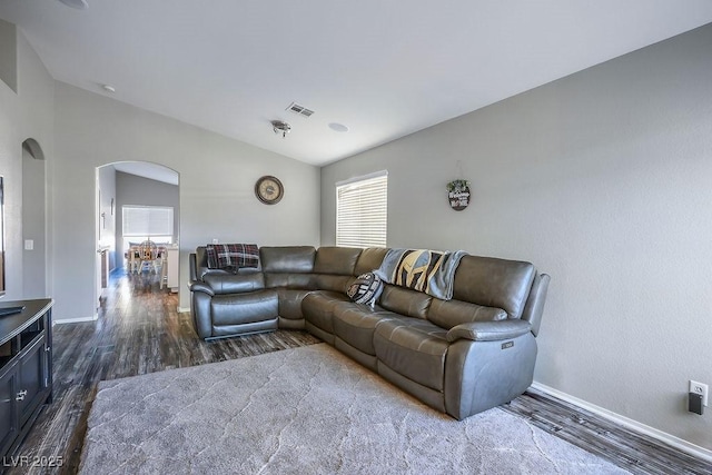 living room featuring lofted ceiling and dark hardwood / wood-style flooring