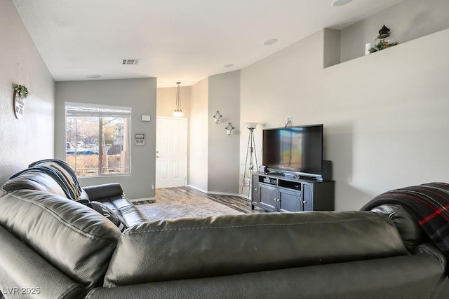 living room with light hardwood / wood-style flooring and vaulted ceiling