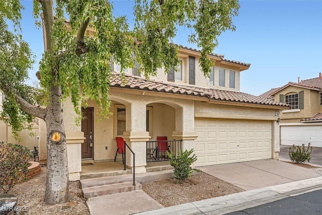 mediterranean / spanish house featuring a porch and a garage