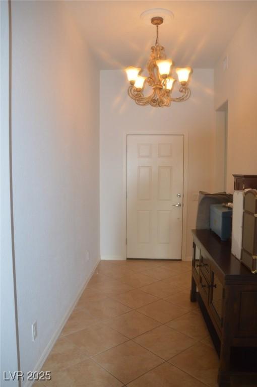 interior space featuring a notable chandelier and light tile patterned flooring