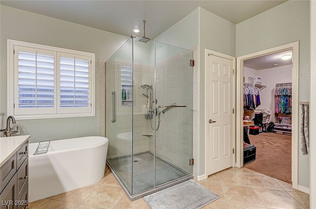 bathroom featuring vanity, separate shower and tub, and tile patterned floors