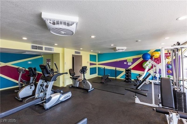 exercise room featuring a textured ceiling