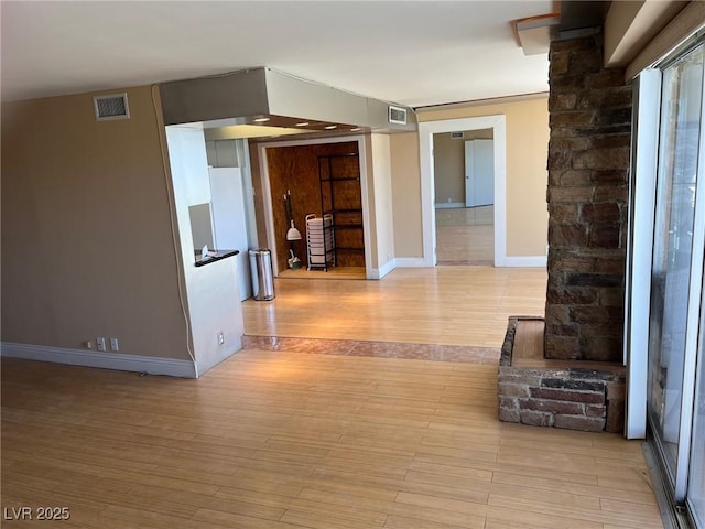 corridor with light hardwood / wood-style floors