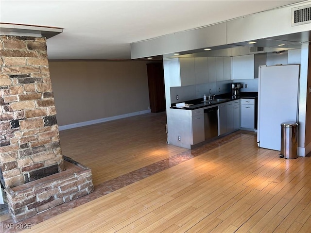 kitchen with dark wood-type flooring, sink, white refrigerator, gray cabinets, and dishwasher