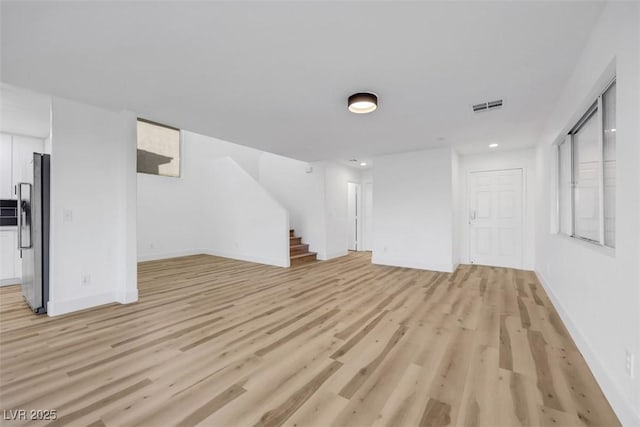 unfurnished living room featuring light wood-type flooring