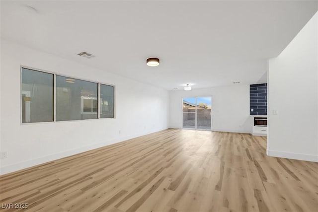 unfurnished living room featuring light wood-type flooring